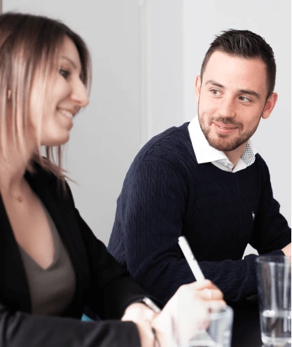 Two Strike employees listen attentively to each other during an experience-sharing meeting.